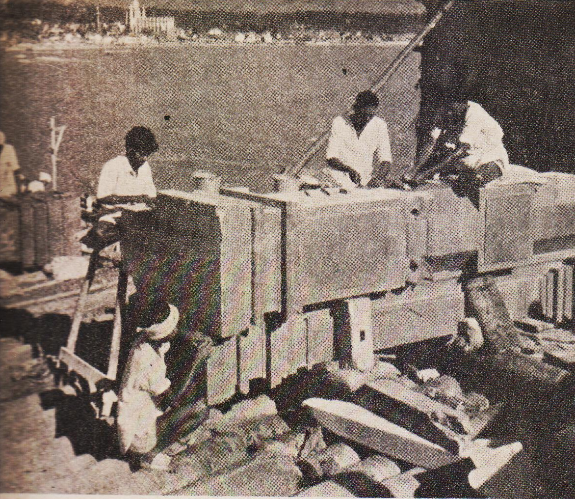 A 13-ton monolitic pillar being dressed on the Rock, preparatory to its erection.