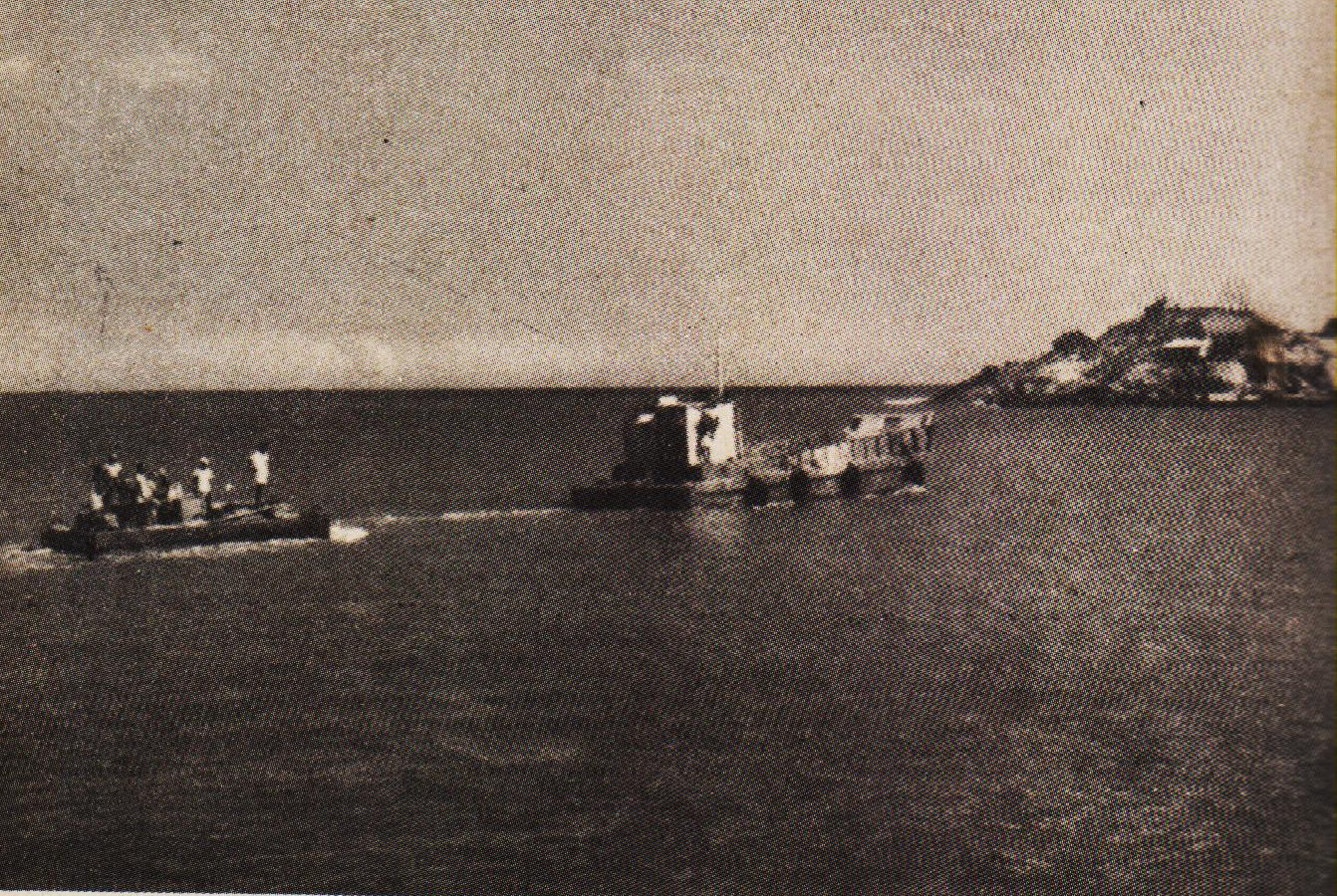 A loaded pontoon being towed to the Rock.