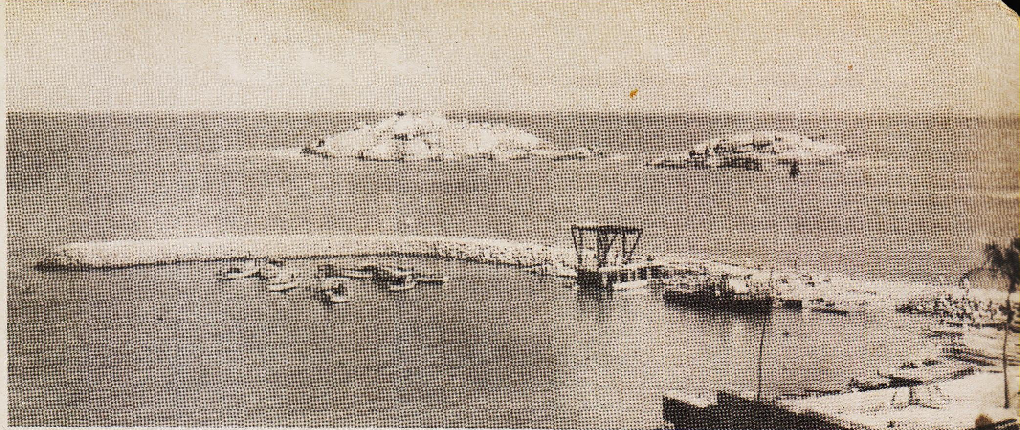 A 580' long L shaped breakwater-wall with jetty-platforms erected at the foot of its inner slopes.