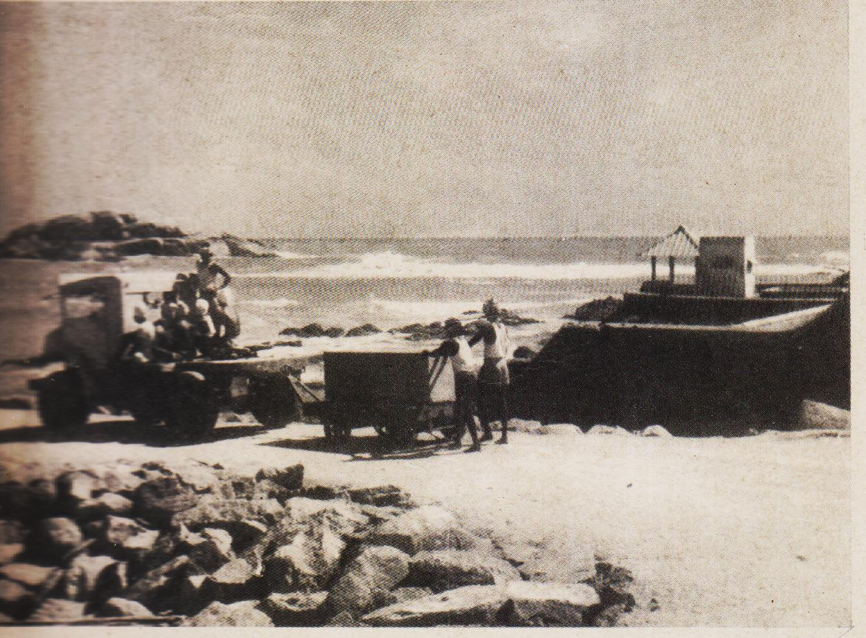 A dressed stone loaded on a trailer being broght to the breakwater-wall.